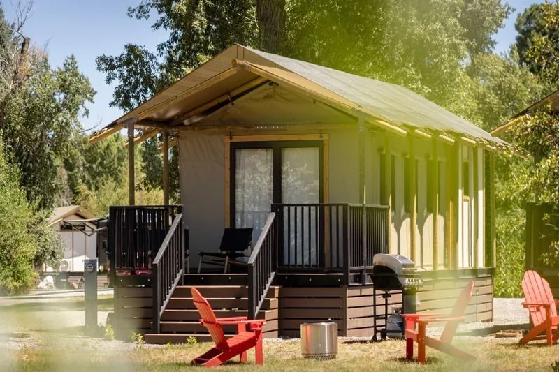 A safari tent with a covered porch and deck at Outdoorsy Bayfield