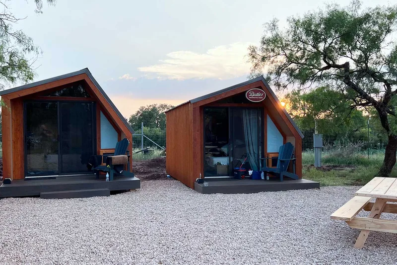 A-frame cabins at sunrise at Austin Moto Adventures